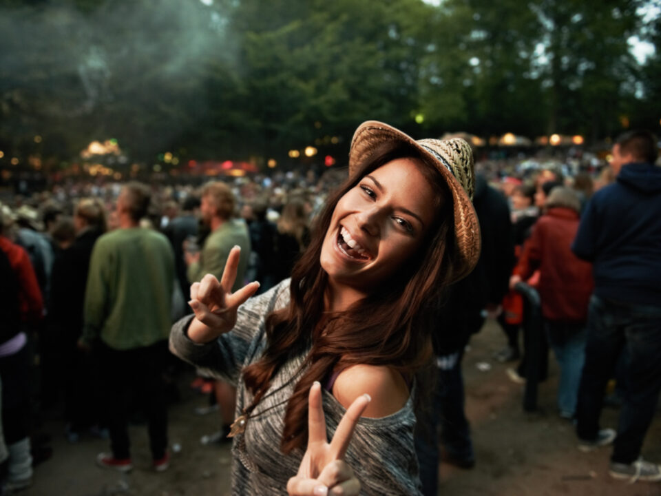 Its all about the vibe. A pretty young woman showing a peace sig